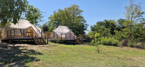 two yurt tents sitting on a hill in a field at Delta Sunrise in Somova