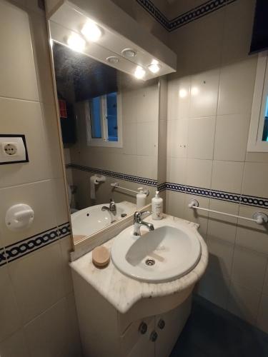 a bathroom with a sink and a mirror at Casa Adosada Mirador de Sevilla in Tomares