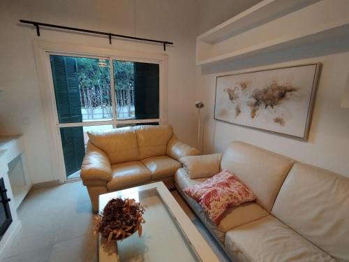 a living room with a couch and a coffee table at Casa Adosada Mirador de Sevilla in Tomares