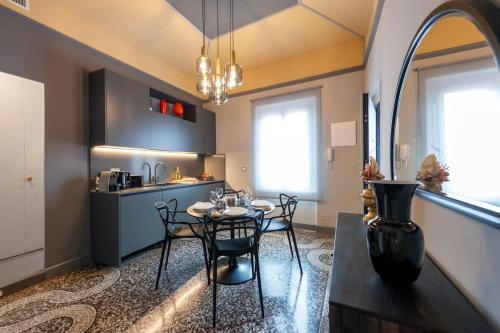 a kitchen and dining room with a table and chairs at La Mirandola - centralissimo luxury loft in Rapallo