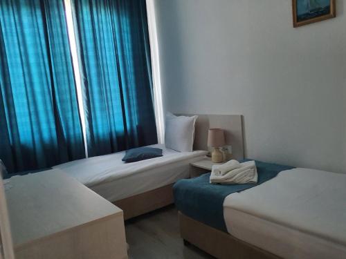 a hotel room with two beds and a window at Guest House Kolev - central in Nesebar