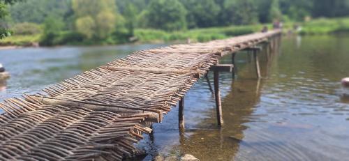 a long wooden bridge over a body of water at Home Sweet Semois in Vresse-sur-Semois