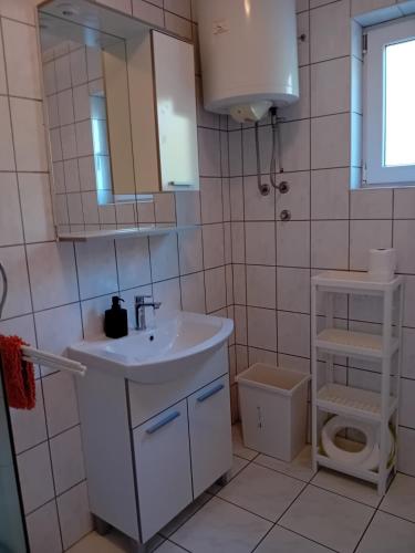 a bathroom with a sink and a toilet at Apartment Mario 2 in Klimno