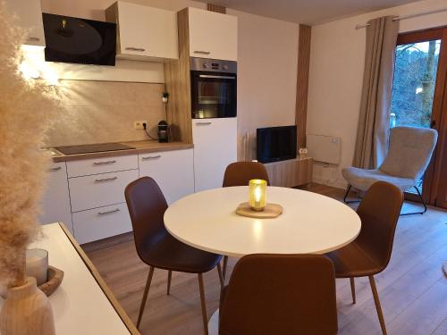 a kitchen and dining room with a table and chairs at Home Sweet Semois in Vresse-sur-Semois