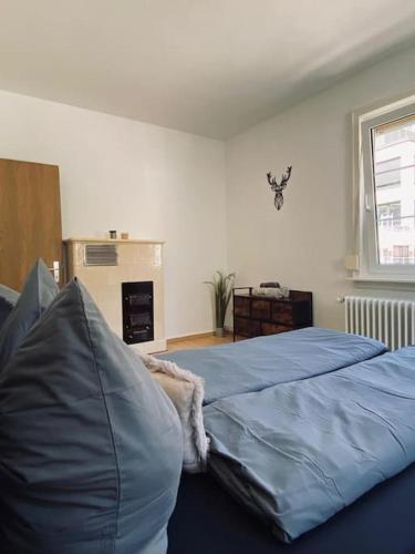 a bedroom with a blue comforter on a bed at Schwarzwald-Idylle in Triberg in Triberg