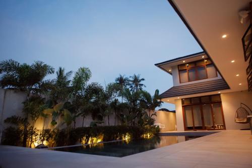 a villa with a swimming pool at night at The Spring House in Irosin