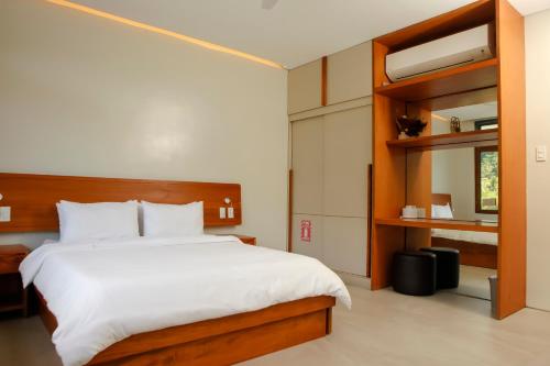a bedroom with a large bed and a book shelf at The Spring House in Irosin