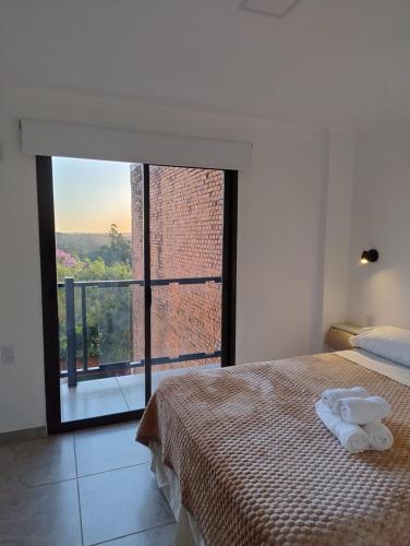 a bedroom with a bed and a large window at Departamentos M&A 1 in Puerto Rico