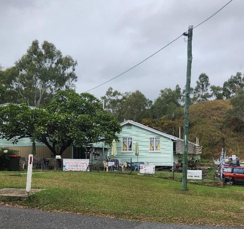 a house on the side of a street with a car at Meyenburg Units in Mount Morgan
