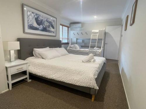 a bedroom with two beds and a ladder at Cool Cabana Mermaid Beach in Gold Coast