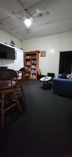 a room with a couch and a table and a whiteboard at Meyenburg Units in Mount Morgan