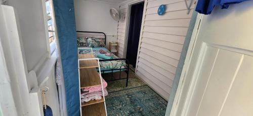 a small room with a bed and a closet at Meyenburg Units in Mount Morgan
