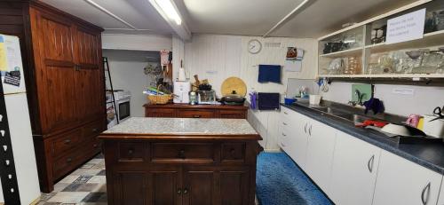 a kitchen with white cabinets and a counter top at Meyenburg Units in Mount Morgan