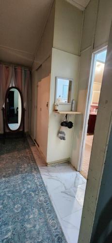 an empty room with a mirror and a hallway at Meyenburg Units in Mount Morgan