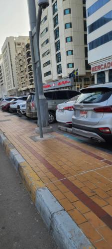a parking lot with a lot of parked cars at Home Away Apartment in Abu Dhabi