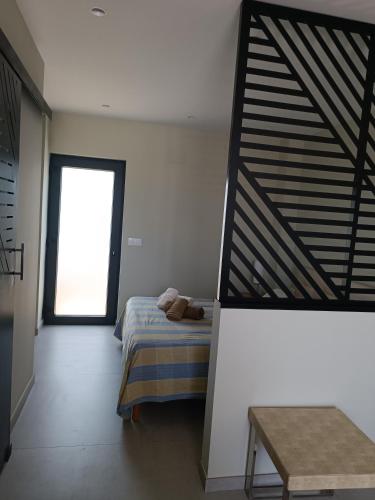 a bedroom with a bed and a window at La Cambreta in Pedreguer