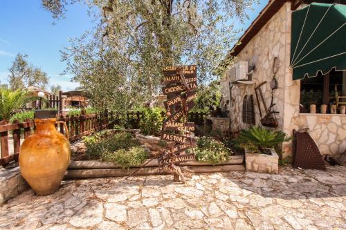 a large vase sitting in front of a building at Tenuta Padre Pio in Vieste