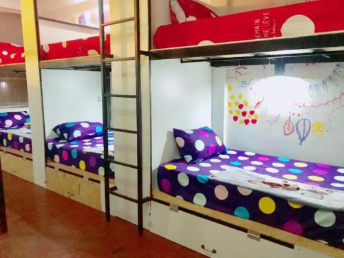 a room with three bunk beds in a dorm at Chiangmai by DD&B hostel in Chiang Mai