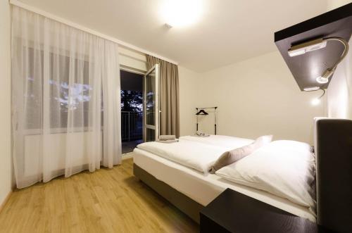 a bedroom with a large bed and a window at Pension Zličín in Prague