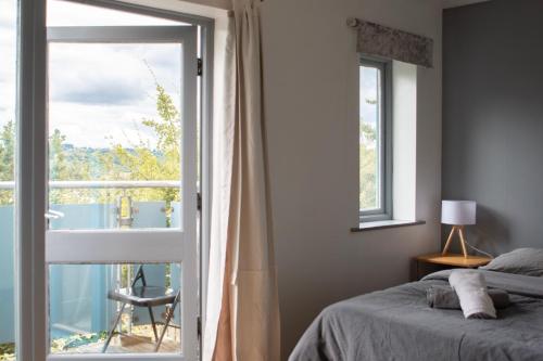 a bedroom with a bed and a large window at Well-equipped 4 Bedroom House close to City Centre in Leeds