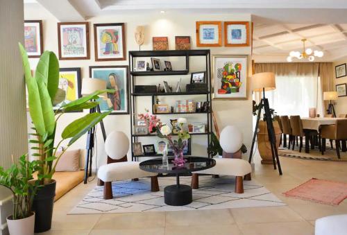 a living room with a table and some chairs at Sweethome in Marrakech
