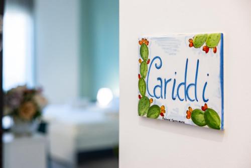 a sign on a wall with the word enrolled at Cariddi in Messina