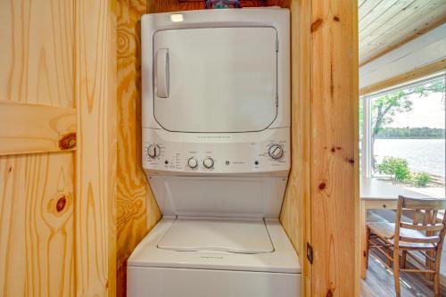 a microwave sitting on top of a washer and dryer at Lake Hubert Cabin with Private Deck and Boat Dock in Nisswa