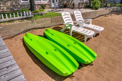 a group of chairs and a green inflatable at Lake Hubert Cabin with Private Deck and Boat Dock in Nisswa