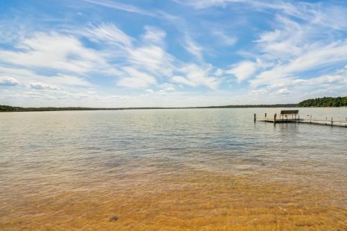 a view of a lake with a dock in the water at Lake Hubert Cabin with Private Deck and Boat Dock in Nisswa