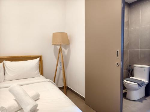a bedroom with a bed and a toilet at Mossaz Suites Empire City By Starwood in Petaling Jaya