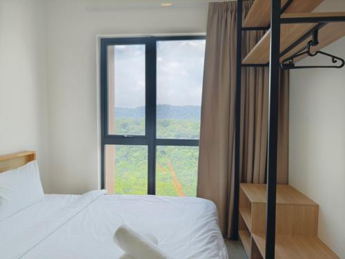 a bedroom with a bunk bed and a large window at Mossaz Suites Empire City By Starwood in Petaling Jaya