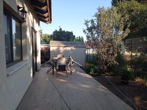 a patio with two chairs and a table on a porch at דצ'א - Дача - Dacha in El-Rom