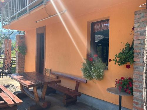 a wooden table and bench next to a building at Bed and Breakfast Family Djukic in Šipovo