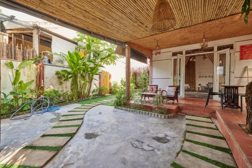 an open courtyard of a house with a patio at Bamboo Garden House By Hoa in An Bang