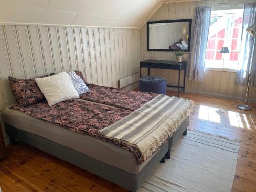 ein Schlafzimmer mit einem großen Bett in einem Zimmer in der Unterkunft Stathelle Heritage Retreat Apartment in Bamble
