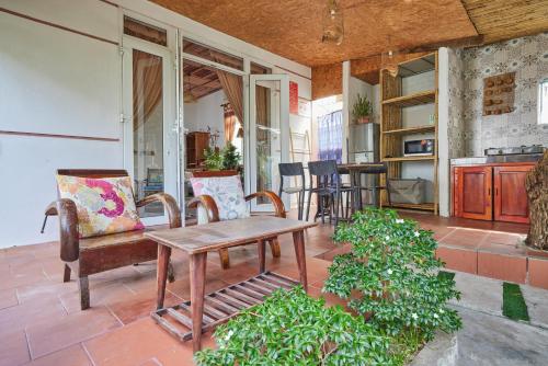a patio with chairs and a wooden table on a patio at Bamboo Garden House By Hoa in An Bang