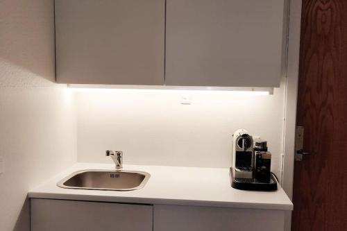 un bancone da cucina con lavello e microonde di 2vær lejlighed - Dronninglund a Dronninglund