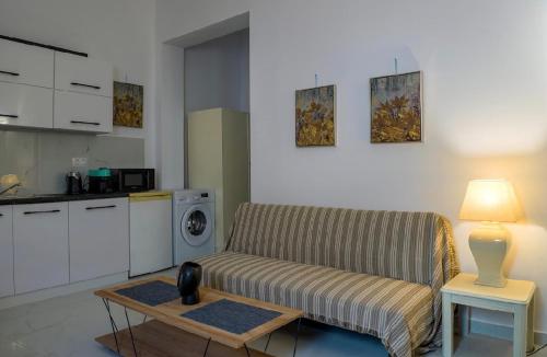 a living room with a couch and a table with a lamp at Andrianas Central House in Agios Rokkos