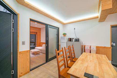 a kitchen and dining room with a table and chairs at Le Village Aewol building A in Jeju