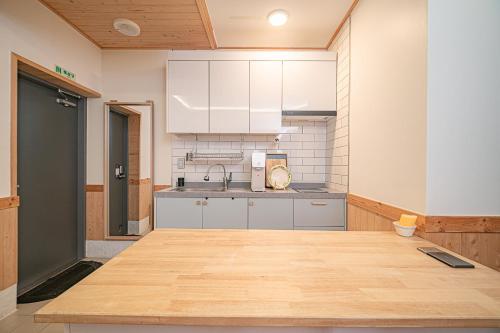 a kitchen with a wooden counter top in a room at Le Village Aewol building A in Jeju