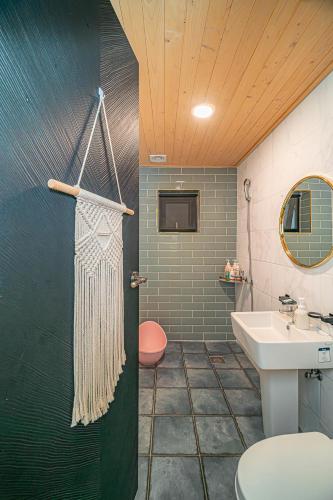 a bathroom with a toilet and a sink at Le Village Aewol building A in Jeju