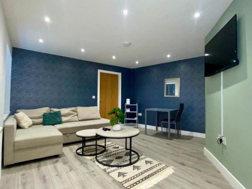 a living room with a couch and a table at Apartment 3 in Manchester