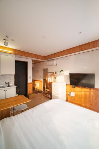 a kitchen with a large white bed in a room at Le Village Aewol building A in Jeju