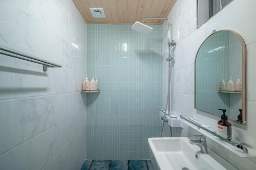 a bathroom with a sink and a mirror at Le Village Aewol building A in Jeju