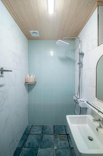 a bathroom with a sink and a mirror at Le Village Aewol building A in Jeju