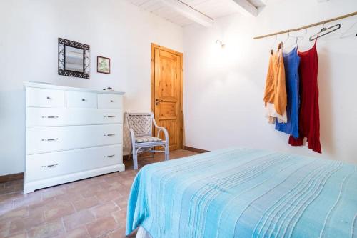 a bedroom with a bed and a dresser and a closet at Casa Sarculla in Testa dellʼAcqua