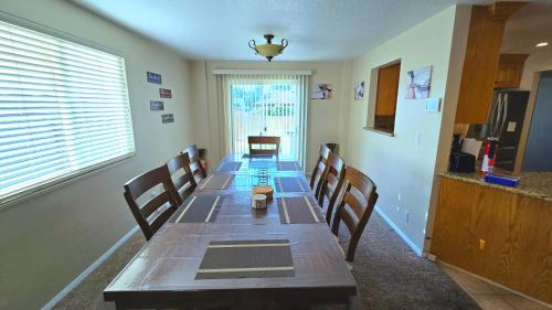 a dining room with a long table and chairs at Booking - Hoskere Homes in Sandy