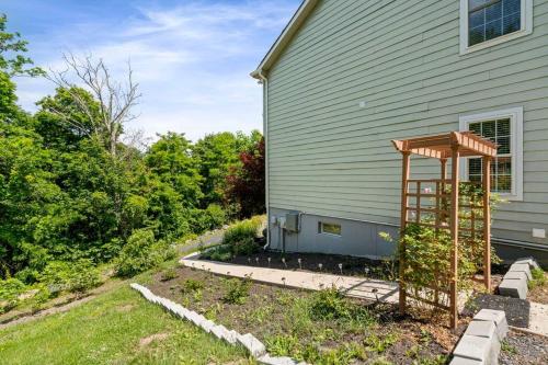 a garden with a pergola next to a house at Multi-gen Family Mountain House in Front Royal