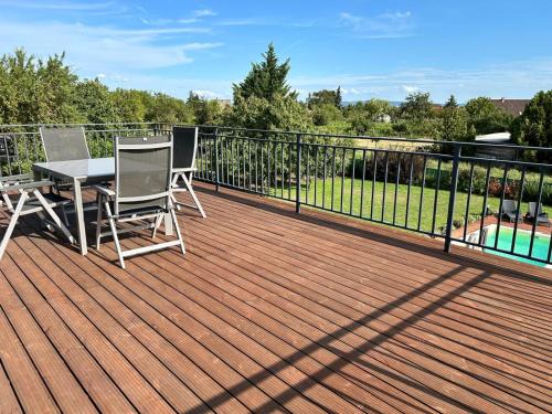 a deck with a table and two chairs on it at Villa Field6 in Révfülöp