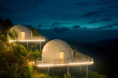two domes on top of a hill at night at Harmony Heights in Mukteswar